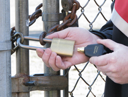 Electronic padlock being opened at gate.